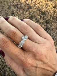 hand with white gold ring and 5 different diamond shapes