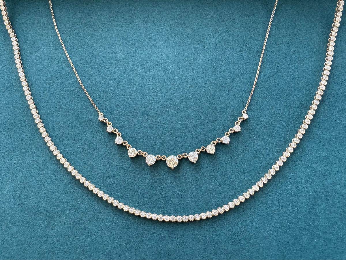 Graduated diamond necklace with 9 diamonds and a bezel set tennis necklace