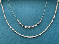 Graduated diamond necklace with 9 diamonds and a bezel set tennis necklace