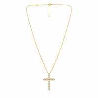 Gold cross necklace with diamonds on a white background