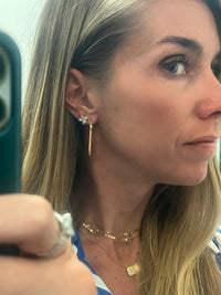 picture  with girl wearing three necklaces and earrings