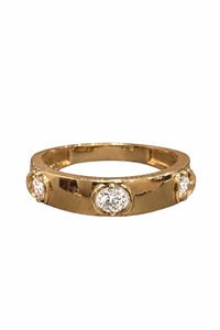 Gold ring with embedded diamonds on a white background