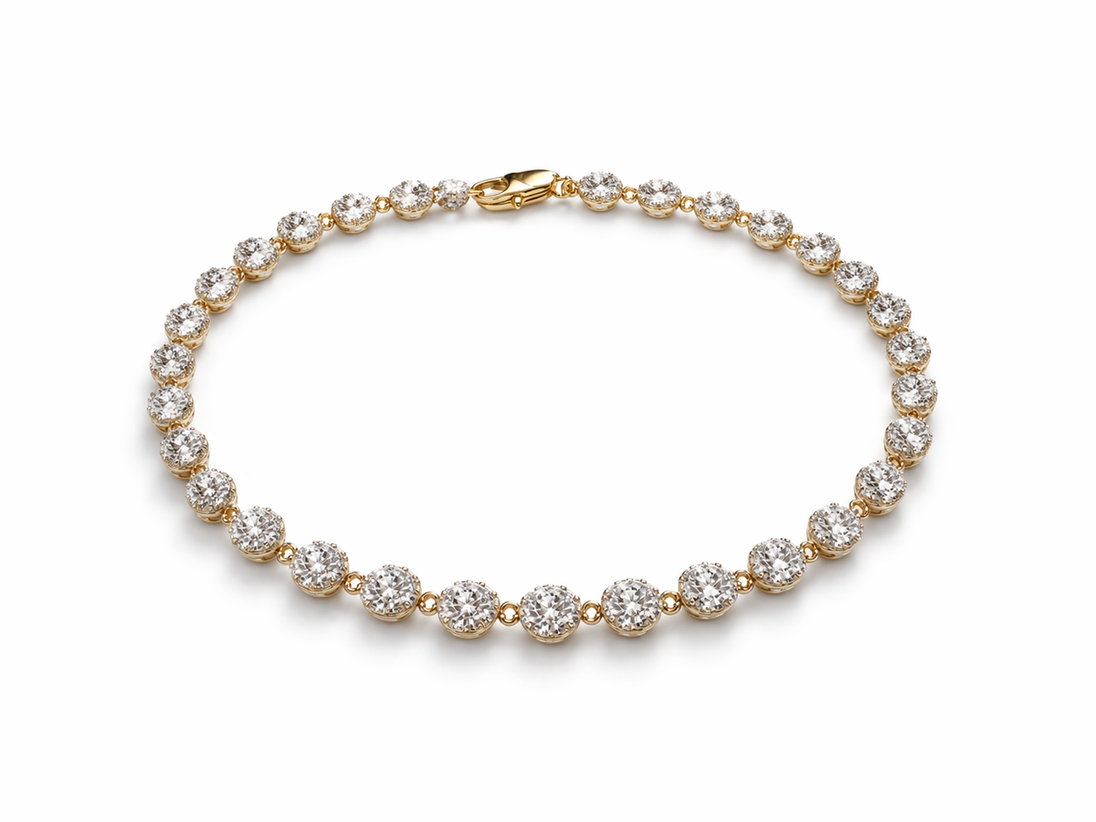 Gold bracelet with clear gemstones on a white background