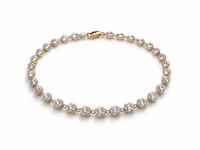 Gold bracelet with clear gemstones on a white background