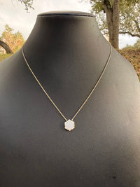 black necklace display with pave diamond hexagon necklace