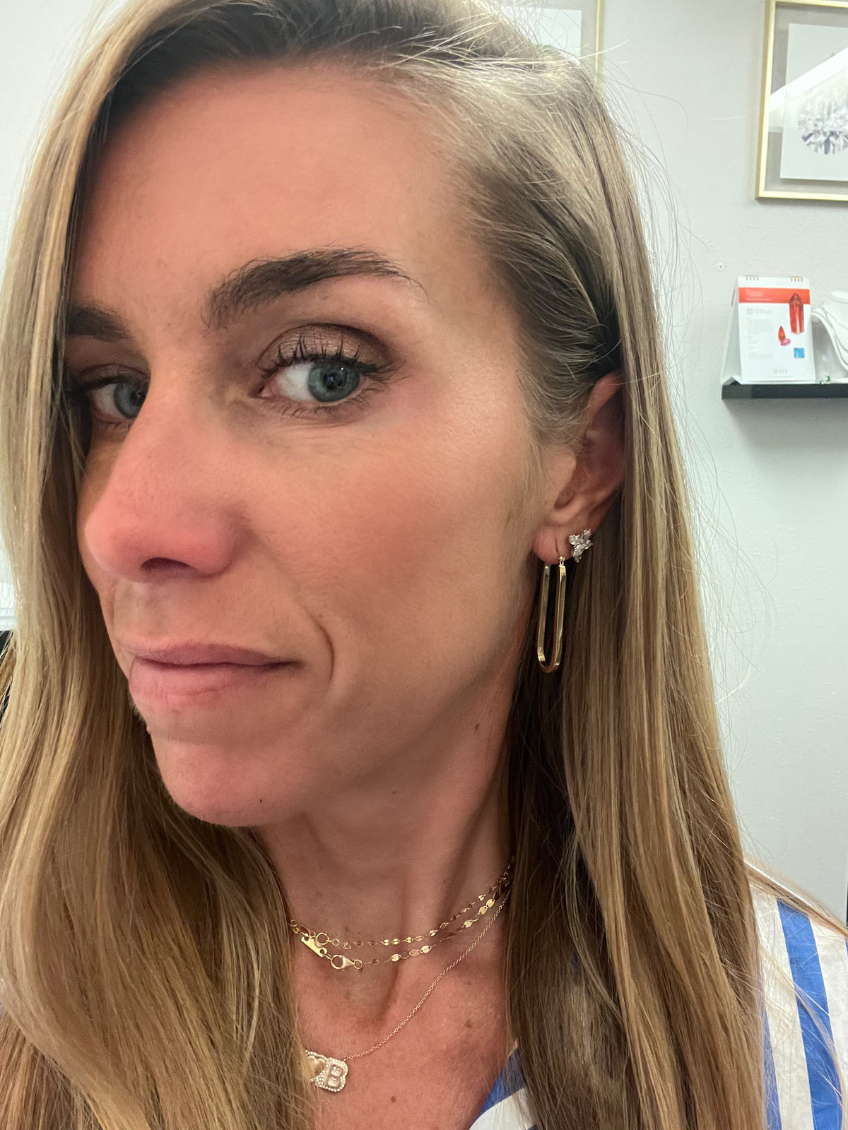 picture  with girl wearing three necklaces and earrings