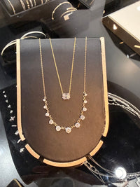 necklace display with 2 diamond necklaces, one solitaire and one 11 diamond necklace