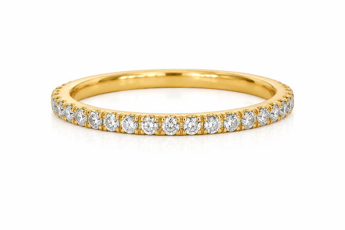 Gold ring with small diamonds on a white background