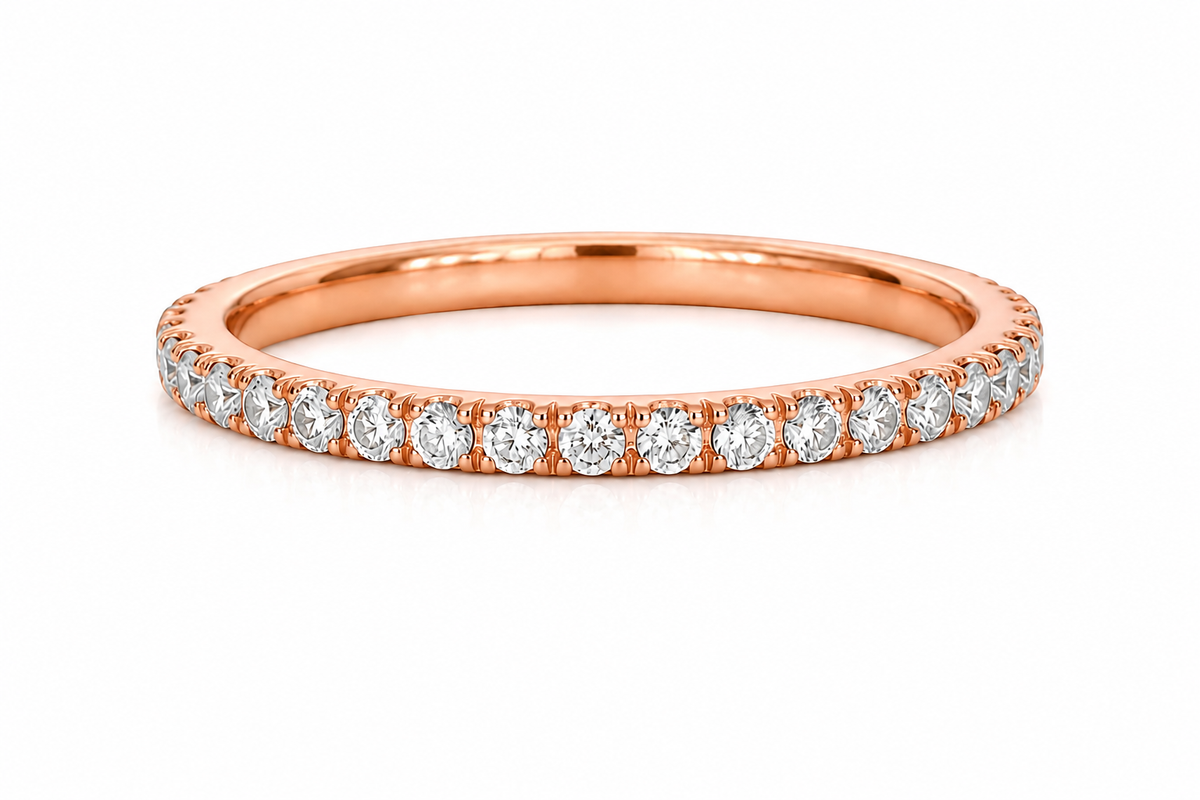 Rose gold ring with diamonds on a white background