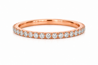 Rose gold ring with diamonds on a white background