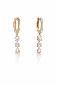 Gold hoop earrings with diamond drops on a white background