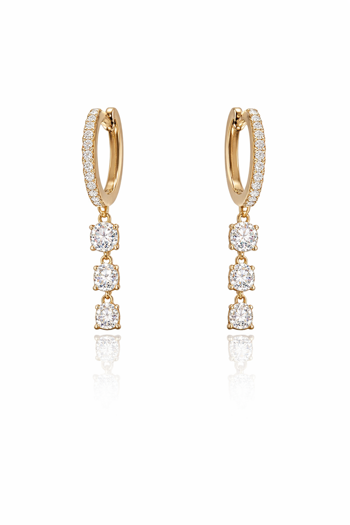 Gold hoop earrings with diamond drops on a white background