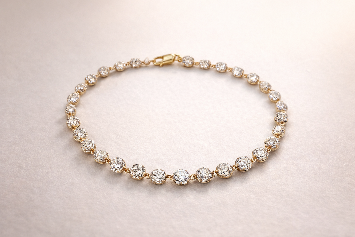 Gold bracelet with diamonds on a light pink background