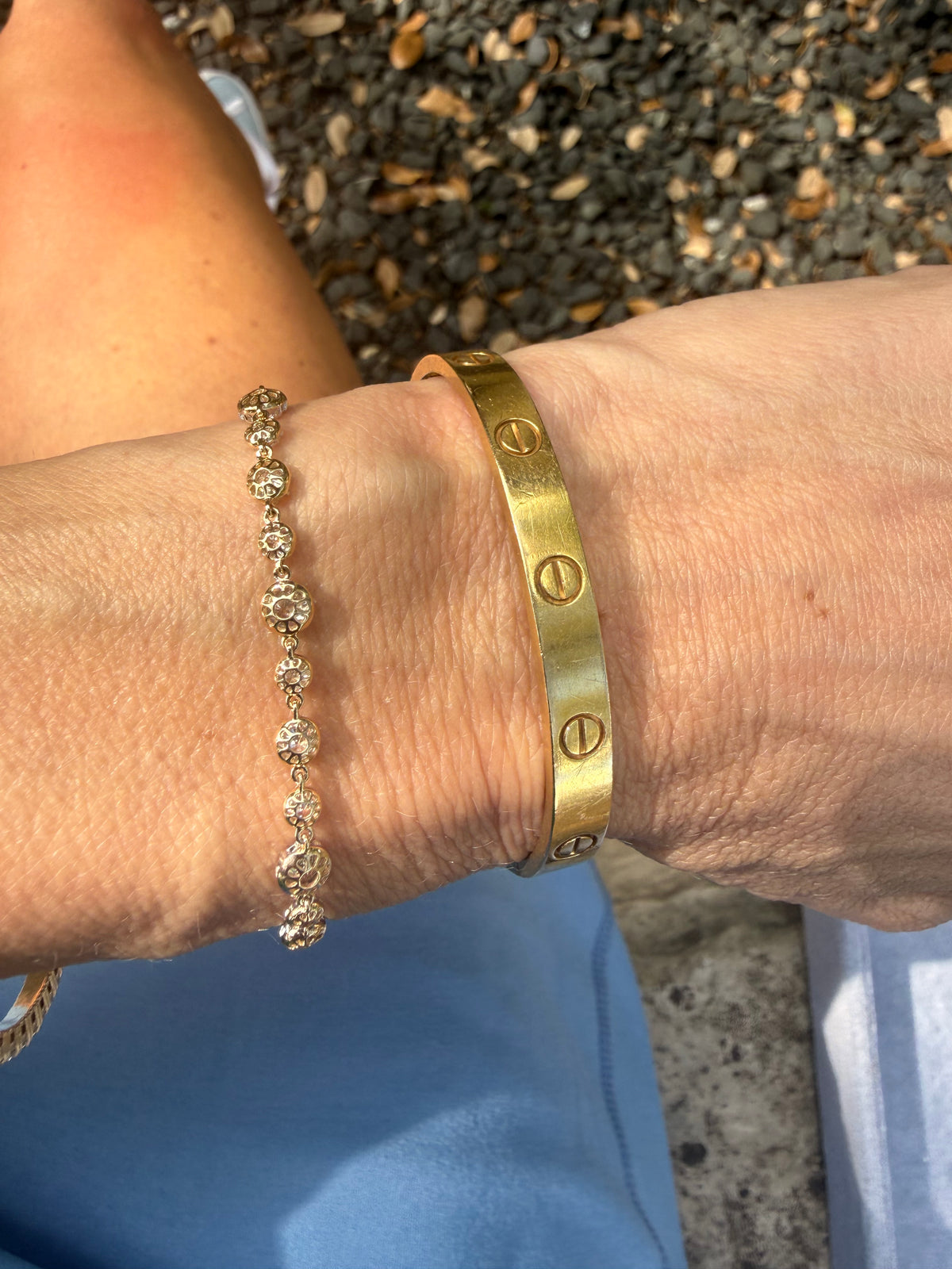 Gold bracelet on a wrist with a blurred background