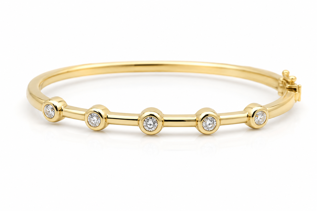 Gold bracelet with small diamonds on a white background