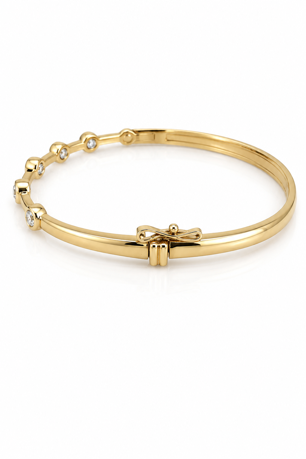 Gold bracelet with bow detail on a white background