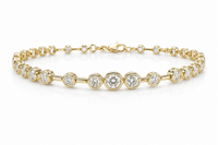 Gold bracelet with bezel set diamond on a white background
