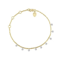 Gold bracelet with small diamonds on a white background