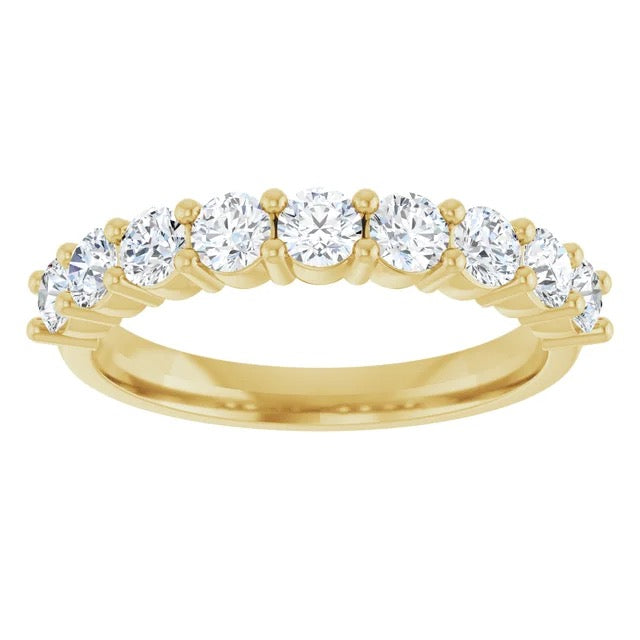 Gold ring with five diamonds on a white background