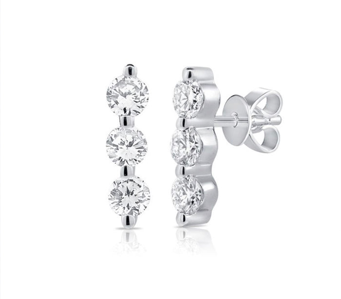 Silver earrings with clear gemstones on a white background