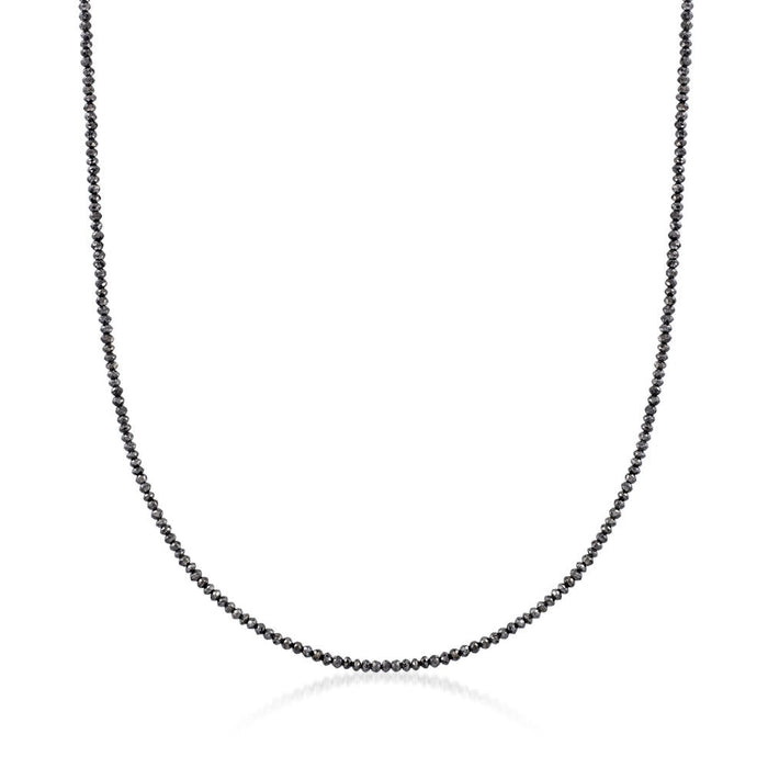 Black beaded necklace on a white background