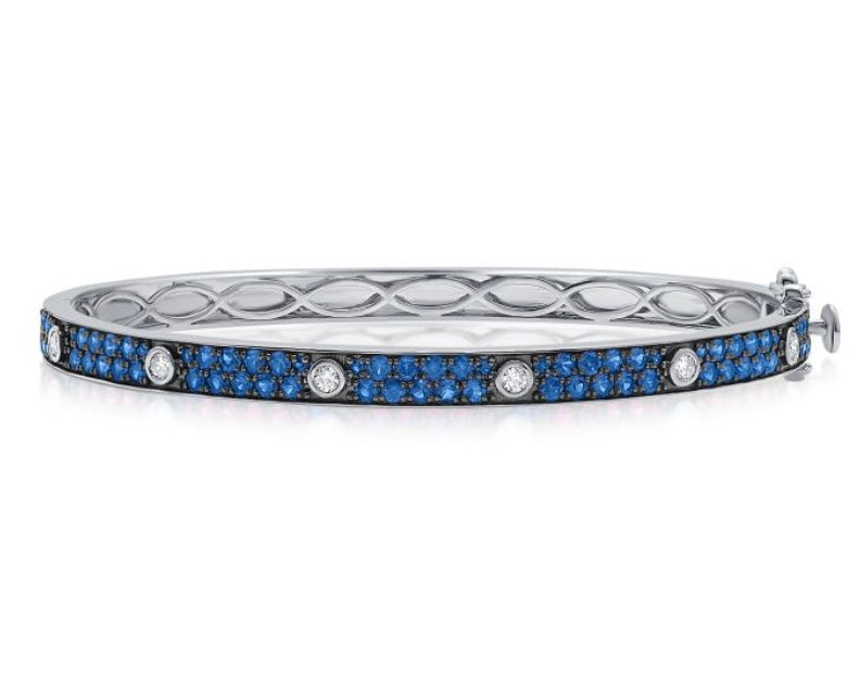 The Karat Concierge Pave Muse bangle in white gold featuring blue pavé gemstones and bezel-set diamonds.