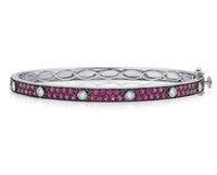 Silver bracelet with pink gemstones on a white background