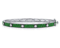 Silver bracelet with green gemstones on a white background