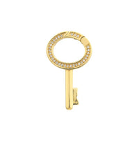 Gold key-shaped earring with gemstones on a white background
