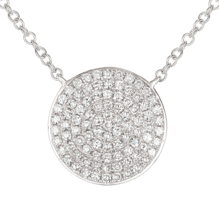 Silver necklace with a round, diamond-studded pendant on a white background