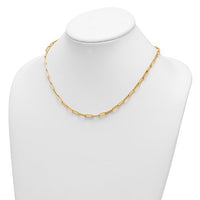 A gold paperclip chain necklace displayed on a white jewelry bust against a white background.