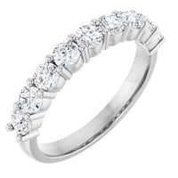 Silver ring with multiple diamonds on a white background