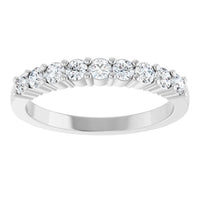 A silver diamond eternity ring featuring a row of round brilliant-cut diamonds set in a polished silver band, shown against a plain white background.