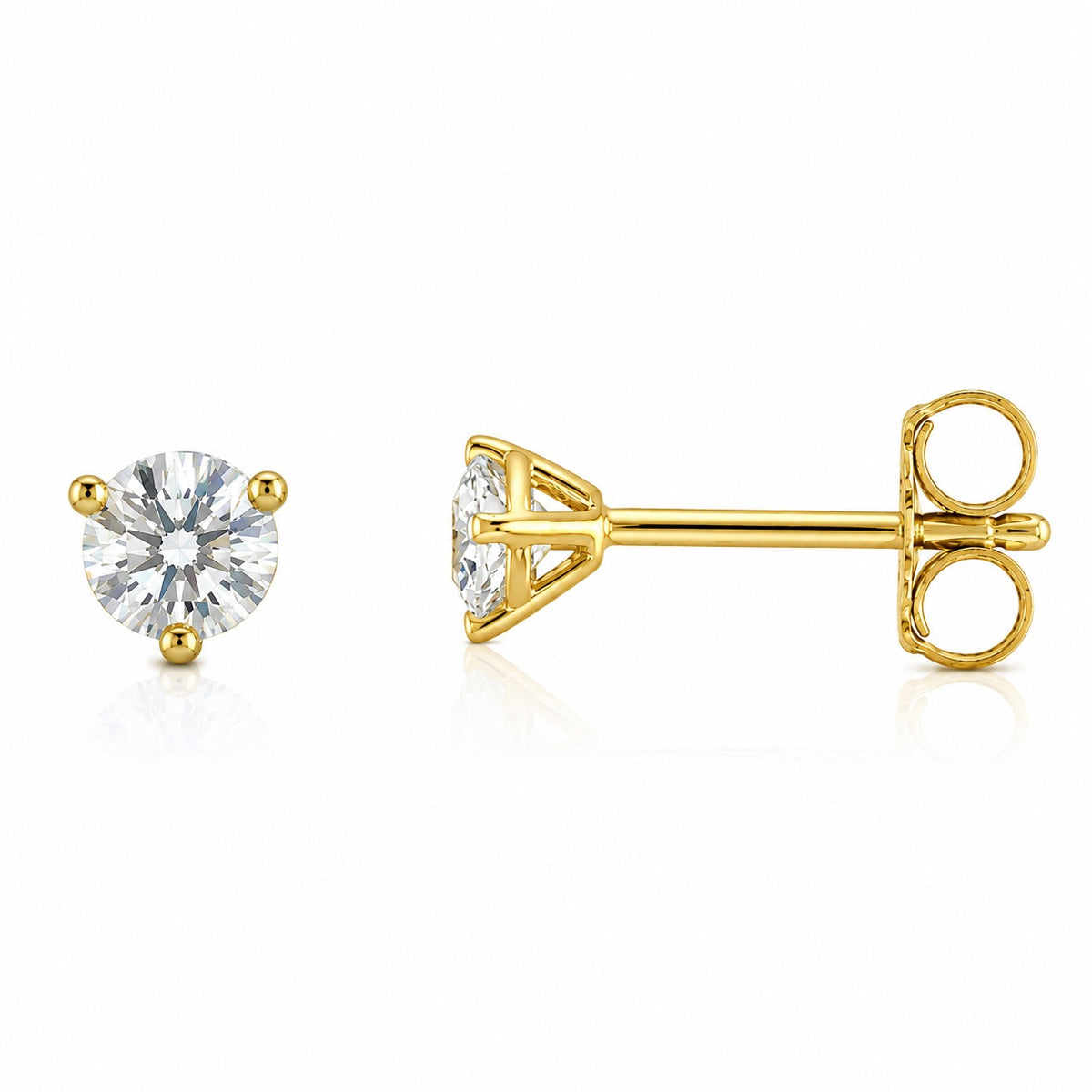 A pair of yellow gold stud earrings, one showing the front view with a round brilliant-cut clear gemstone and the other showing the side profile with the post and butterfly back, on a white background.