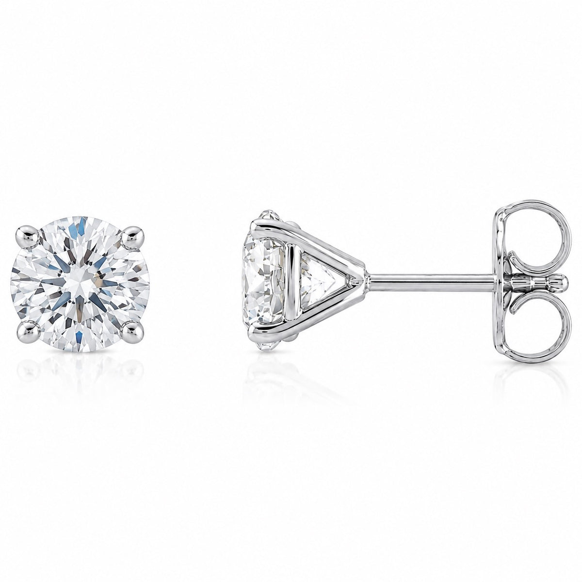 A pair of round brilliant-cut diamond stud earrings in a silver-tone setting, shown from the front and side profile on a clean white background.