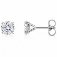 A pair of round brilliant-cut diamond stud earrings in a silver-tone setting, shown from the front and side profile on a clean white background.
