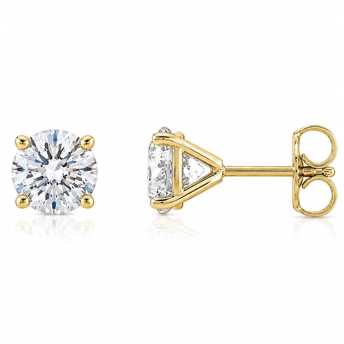 A pair of yellow gold stud earrings, one shown from the front with a round brilliant-cut clear gemstone and the other from the side showing the triangular prong setting and post with butterfly back, on a white background.