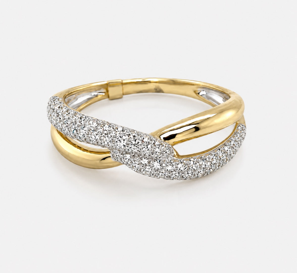 A gold twist ring featuring a pavé-set silver band with pave diamonds, shown on a light gray background.