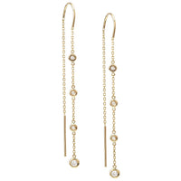 Gold threader earrings with small diamonds on a white background