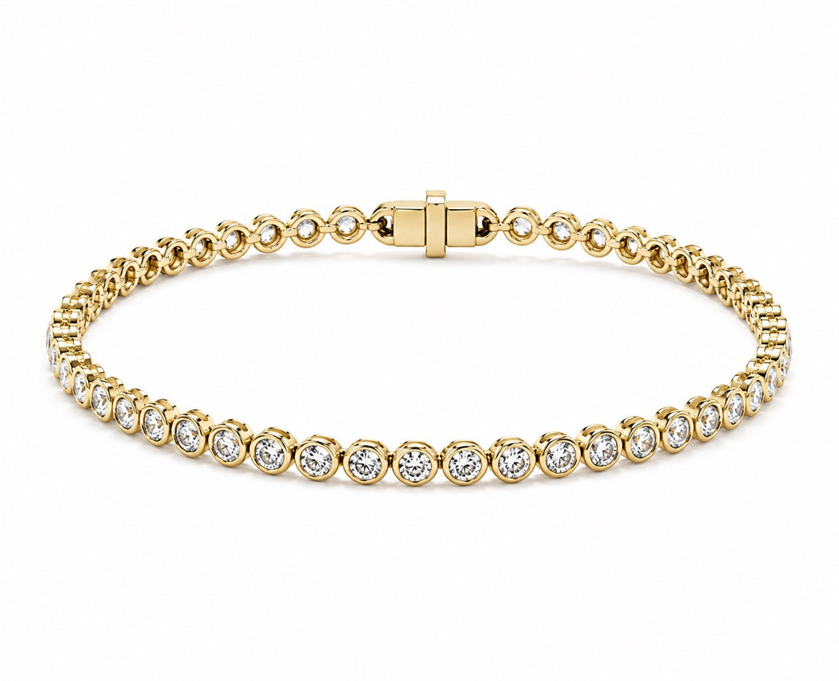 A yellow gold tennis bracelet featuring round diamond in a classic bezel set design, displayed on a clean white background.