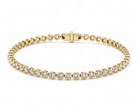 A yellow gold tennis bracelet featuring round diamond in a classic bezel set design, displayed on a clean white background.