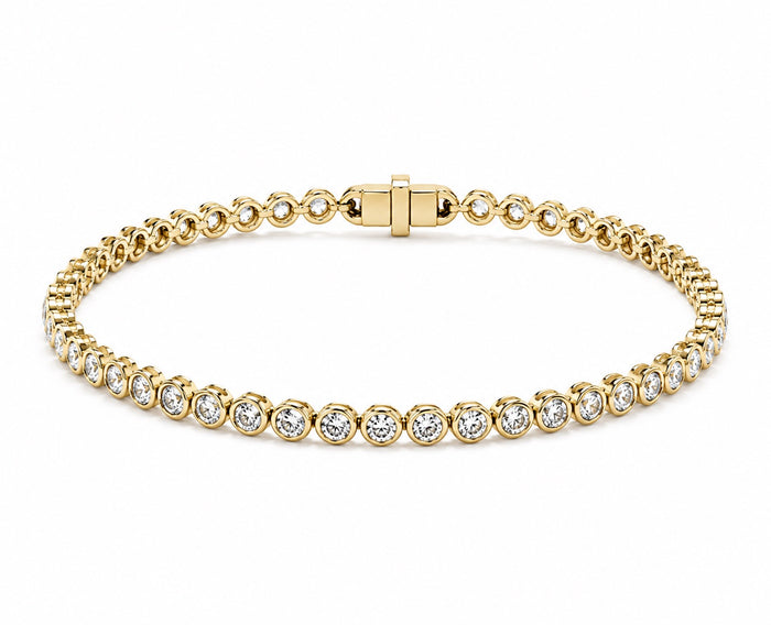 A yellow gold tennis bracelet featuring round diamond in a classic bezel set design, displayed on a clean white background.
