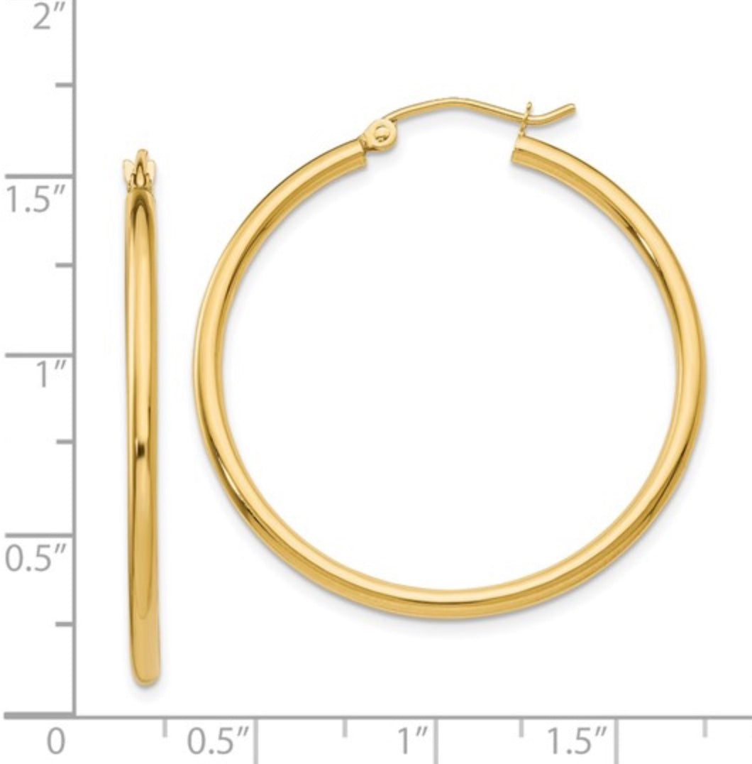 The Karat Concierge 1.5 inch hoop earrings crafted from polished 14K yellow gold with a classic round design.