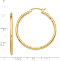 The Karat Concierge 1.5 inch hoop earrings crafted from polished 14K yellow gold with a classic round design.