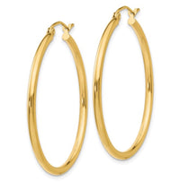 The Karat Concierge 1.5-inch hoop earrings crafted from polished 14K yellow gold with a lightweight, elegant design.