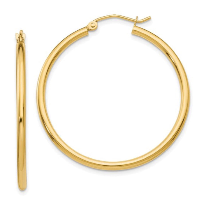 The Karat Concierge 1.5-inch hoop earrings crafted from polished 14K yellow gold with a classic hinged closure.