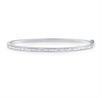 The Karat Concierge channel set bangle featuring baguette diamonds in white gold with a double safety latch