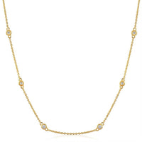 The Karat Concierge diamonds by the yard necklace in 14K yellow gold with bezel set natural diamonds on a delicate chain