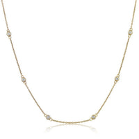 The Karat Concierge diamonds by the yard necklace in 14K yellow gold with bezel set round brilliant diamonds.