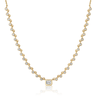 The Karat Concierge Peyton bezel set necklace in 14K yellow gold with emerald cut and round brilliant diamonds.
